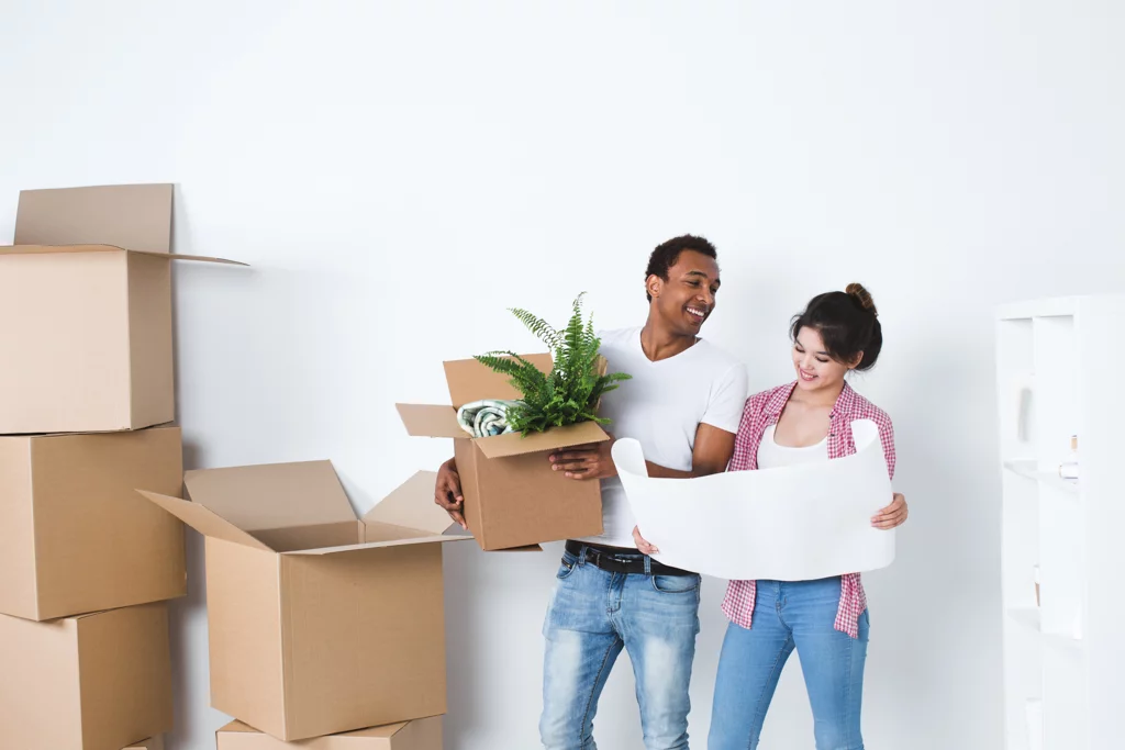 Couple holding cardboard boxes