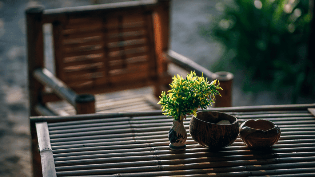 Garden chair and table with small plants on it